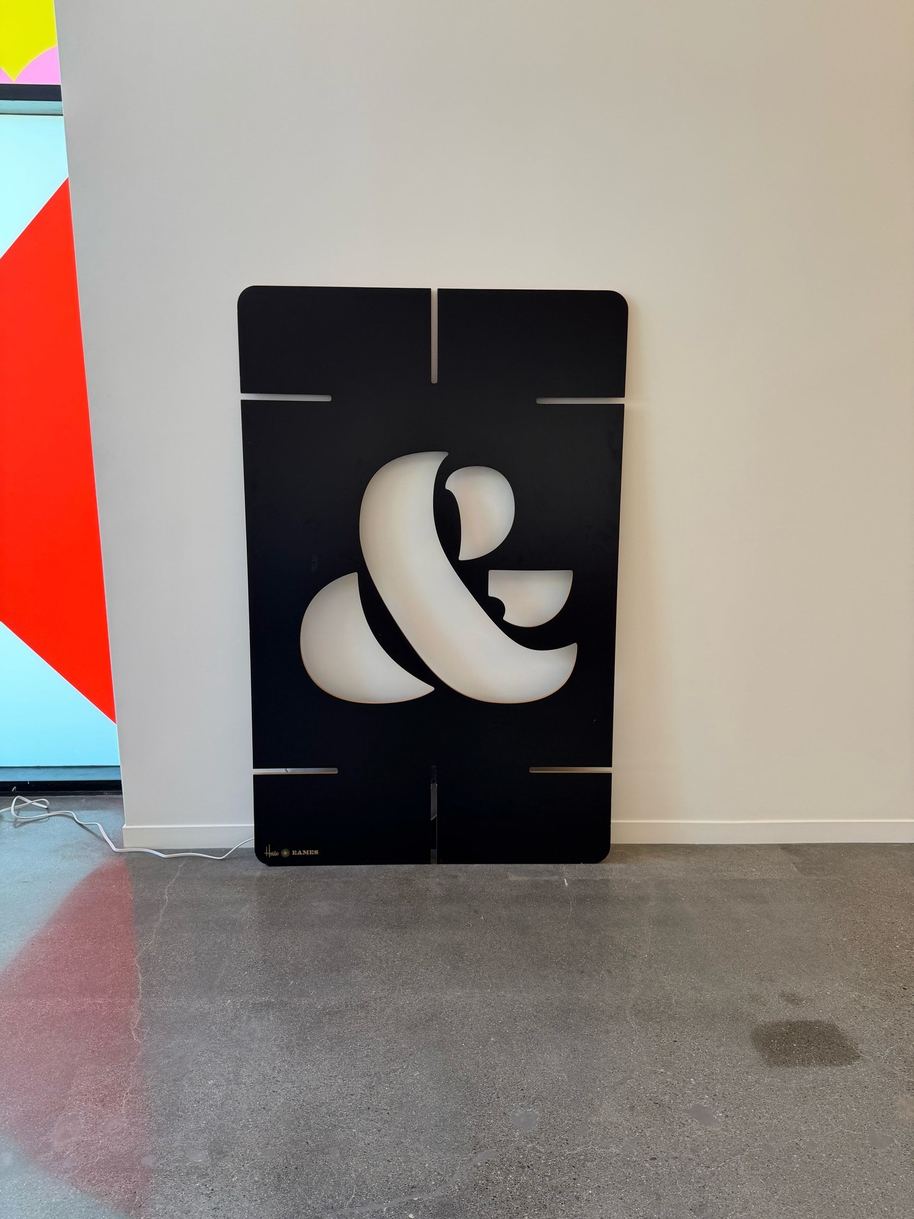 Large cutout of an ampersand, in the lobby of the Eames Archives.